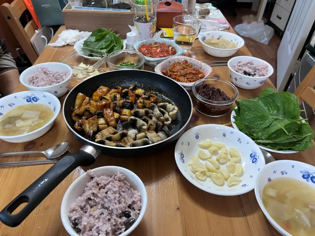 Korean breakfast with multigrain rice, soup, kimchi, and a simple main dish
